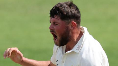 Tom Norton shouts to celebrate a wicket