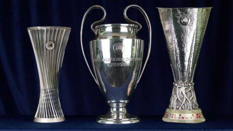 Picture of the Champions League, Europa League and Conference League trophies