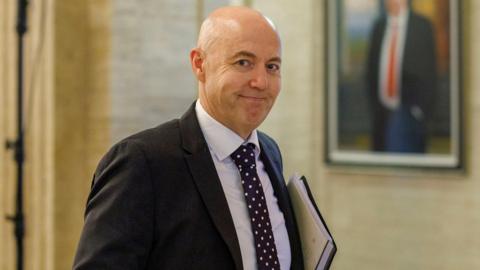 UUP leader Jon Burrows MLA at Parliament Buildings, Stormont, he has a dark suit and white shirt