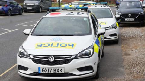 Two police cars parked on Gossops Drive in Crawley
