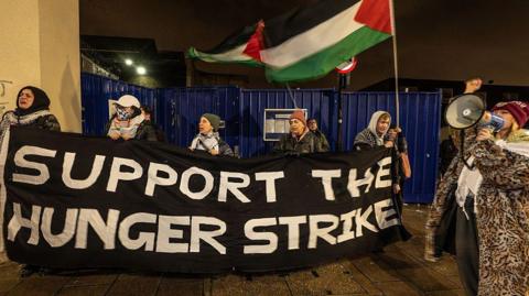 A protest outside a prison in support of prisoners on hunger strike over Palestine-related causes