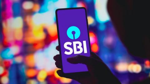 In this photo illustration, the State Bank of India (SBI) logo is displayed on a smartphone screen.