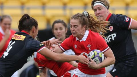 Lisa Neumann of Wales tries to break free against Canada