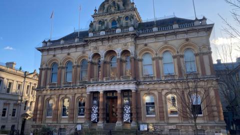 The front of Ipswich Town Hall, which has steps and columns in front of the main entrance.