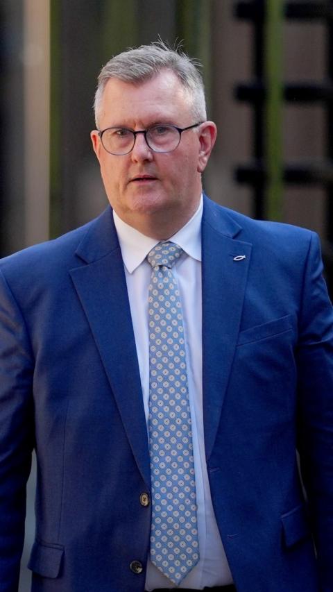 Jeffrey Donaldson walks outside of court following his child sex abuse trial. He is wearing a blue suit with a blue and white patterned tie and a white shirt. He is an older man with short, greying hair and a pair of circle glasses.
