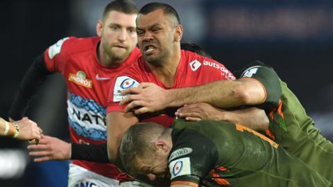 Kurtley Beale of Racing 92 is tackled by Keiran Williams and Rhys Davies