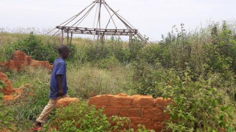 A boy walks past the ruins of the destroyed house of customary chief Kamuina Nsapu, whose death last August sparked months of deadly fighting between the government army and Kamuina Nsapu"s militia in Tshimbulu near Kananga, the capital of Kasai-central province of the Democratic Republic of Congo, March 11, 2017.