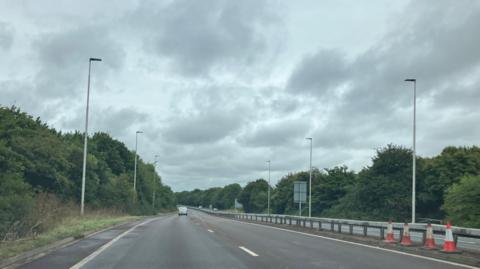 Longthorpe Parkway stretch of road with lampposts and trees on either side