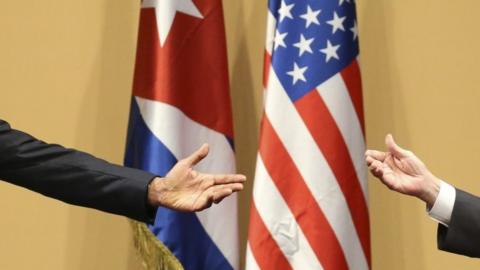 US President Barack Obama and Cuban President Raul Castro (their faces not seen) gesture during a news conference in Havana