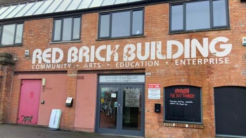 Red Brick building which says 'Red Brick Building' above the door