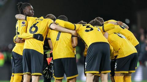 Wolves players in a huddle before a match
