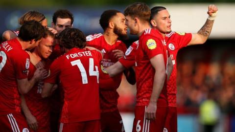 Crawley Town players celebrate scoring against MK Dons