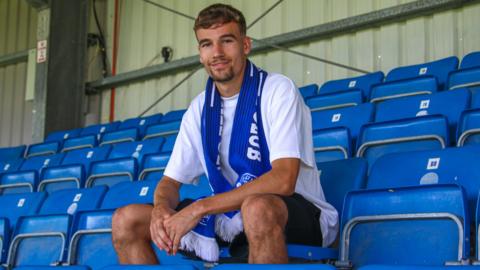Reece Johnson poses for a photo after signing for Eastleigh on loan