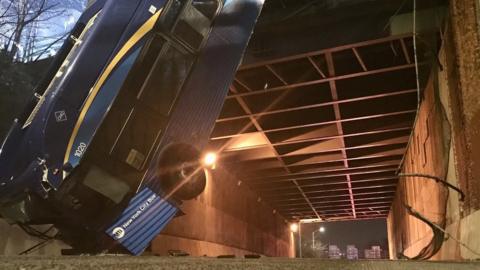 Image from Twitter showing bus hanging from overpass in New York