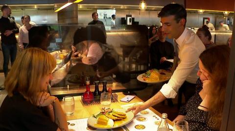 Rishi Sunak serving meals to customers