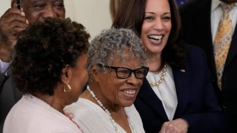 94-year-old activist and retired educator Opal Lee holds hands with Vice President Kamala Harris in the White House as law making 19 June a national holiday is signed