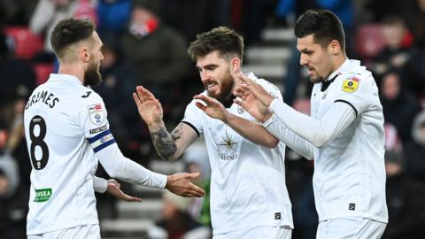 Matt Grimes, Ryan Manning and Joel Piroe celebrate