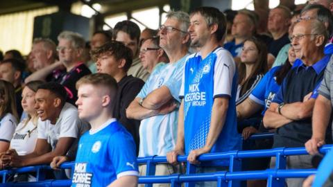 Peterborough fans watching their team against Lincoln City