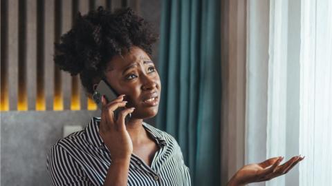 Woman on the phone looking exasperated