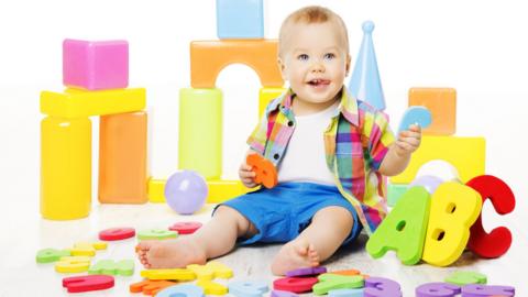 toddler with alphabet blocks