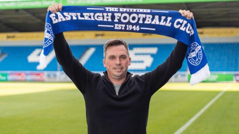 Scott Bartlett poses with an Eastleigh FC scarf after being named new manager 