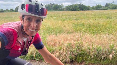 Michelle Sharland riding her bike in countryside