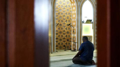 A man prays in a mosque in Liverpool