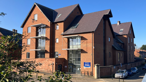 Shropshire Council's Guildhall is a red brick building. At the side are a number of cars
