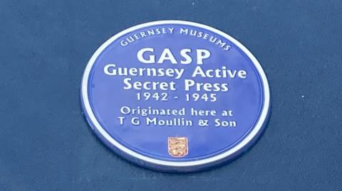 The blue plaque engraved with the words: GASP - Guernsey Active Secret Press 1942-1945. Originated here at T G Moullin & Son.