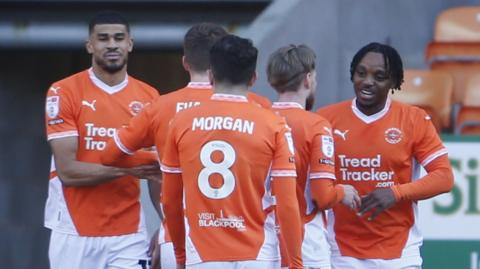 Blackpool's Niall Ennis celebrates scoring with his team-mates