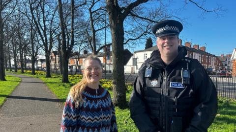 Elly Cutkelvin and Paul Crewe stood in the sunshine on a park just off a road in Saffron Lane