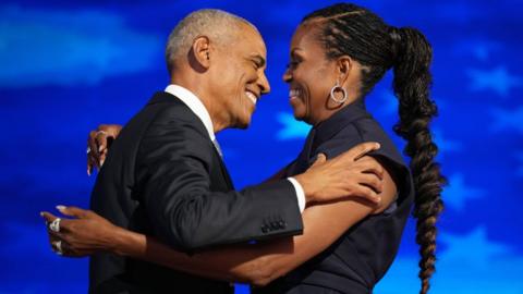 Former U.S. President Barack Obama greets former first lady Michelle Obama as he arrives to speak on stage during the second day of the Democratic National Convention at the United Center on 20 August 2024 in Chicago, Illinois