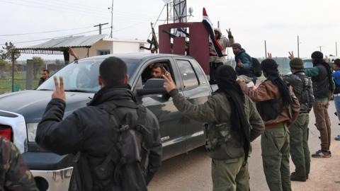 Syrian Kurdish fighters welcome pro-government forces to the Kurdish enclave of Afrin to help them combat Turkish forces (20 February 2018)