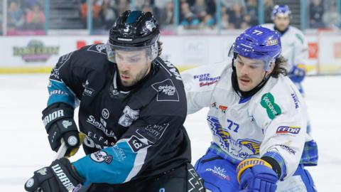 Belfast's Bo Hanson is challenged by Flyers opponent Drake Pilon 