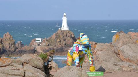 Gorilla statue in front of lighthouse