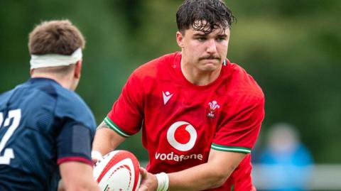 Evan Wood in action for Wales Under-20s against England