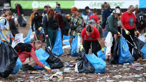 People cleaning up Worthy Farm