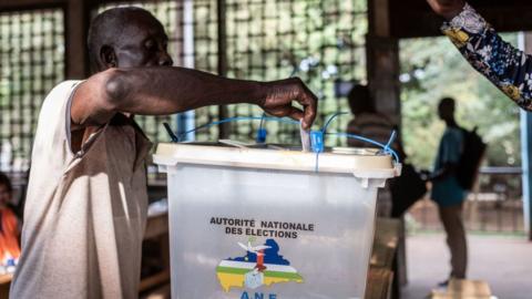 A voter casts his ballot at the Boganda high school in Bangui, on July 30, 2023