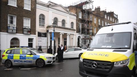 Police gather outside the Angel Church in north London, Britain,