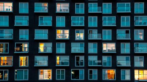 A block of flats at night in London