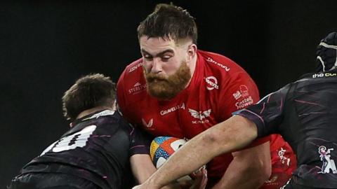 Kemsley Mathias going into a double tackle