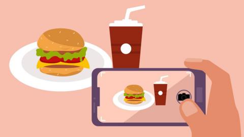 An illustration of a smartphone taking a picture of a burger and a drink