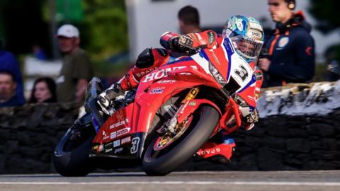 Dean Harrison on his machine which is in the Honda team colours of red white and blue.
