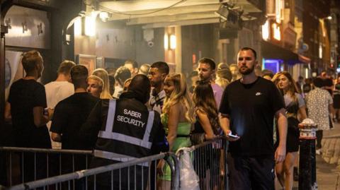 Queues of young people outside a nightclub