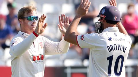 Essex bowler Simon Harmer (left) celebrates a wicket