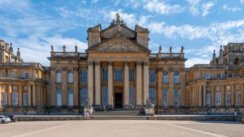 The grand entrance steps of Blenheim Palace under a clear sky.