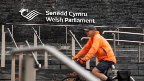 Cyclist in front of the Senedd
