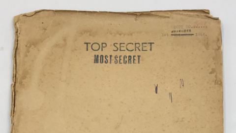 An old manila envelope that is stained and bent at the corners. In typed lettering, it reads: 1 November 1944. Top Secret. Most Secret.