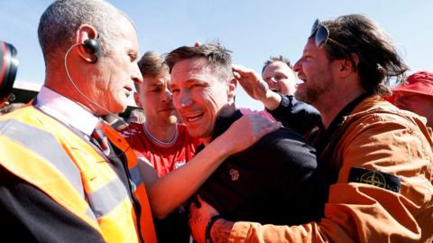 York boss Stuart Maynard is mobbed by supporters at full-time
