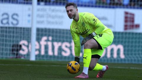 Ross Fitzsimons prepares to roll the ball out to a Northampton Town team-mate